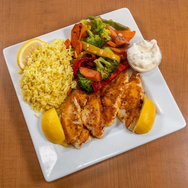Prime 7 Bar & Restaurant's American dish with fried fish, yellow rice, mixed vegetables, and tartar sauce.